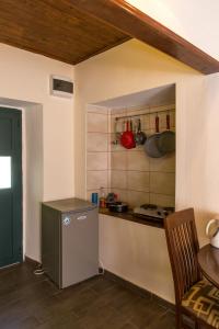 a kitchen with a small refrigerator and a counter at Apartments Kole in Rafailovici