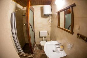 a bathroom with a sink and a toilet and a mirror at Apartments Kole in Rafailovici