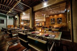 a restaurant with tables and chairs and a bar at Wyndham Casablanca Jakarta in Jakarta