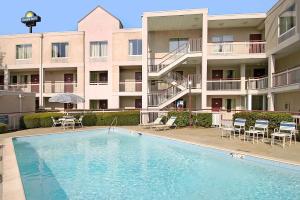 a swimming pool in front of a apartment building at Days Inn by Wyndham Atlanta/Southlake/Morrow in Morrow