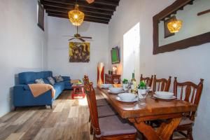 a dining room with a table and a blue couch at Casa Vieja, 4 bedroom villa with a private pool in Mácher