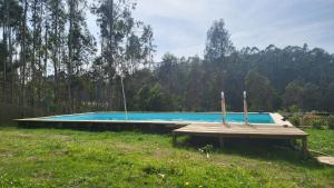 a swimming pool with three candles on a wooden table at WoodHouse Near River - Near Ocean - Near Porto in Porto