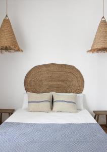 a bedroom with a bed with two pillows at Santa Clara Old Town in Albufeira