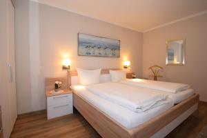 Postel nebo postele na pokoji v ubytování Haus Seewärts Wohnen Apartment 3 1