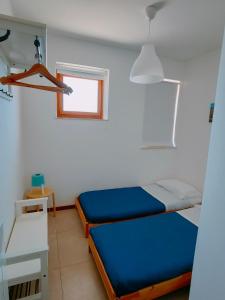 A bed or beds in a room at Mondello Sabrina Apartments
