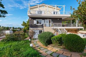 a house with a balcony on top of it at Villa Stilvi II - Α Full of Positive Energy House in Chalkida