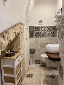 a bathroom with a white sink and a toilet at Domus Klara in Turi +64 photos