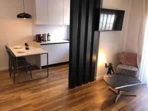 een keuken en een woonkamer met een tafel en een stoel bij Skanderbeg Center Apartments 1 in Tirana