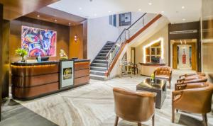 a lobby of a hotel with a staircase and chairs at The Citi Residenci Hotel - Asansol in Āsansol