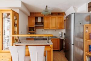 a kitchen with a wooden table and a refrigerator at HOUSE MIRKO- center of Split in Split