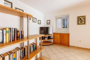 a living room with bookshelves and a tv at HOUSE MIRKO- center of Split in Split