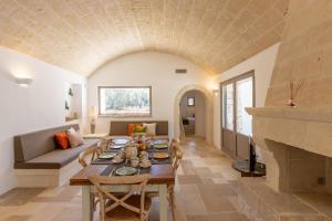 a living room with a table and a couch at Lamia del Bosco con Piscina in Ostuni