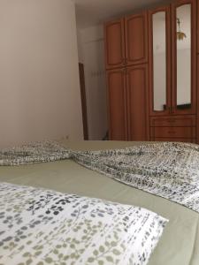 a bedroom with a bed with a white comforter at Home in Vlorë +3 photos