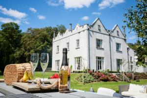 a table with a bottle of wine and two glasses at Annamult Country House Estate in Kilkenny
