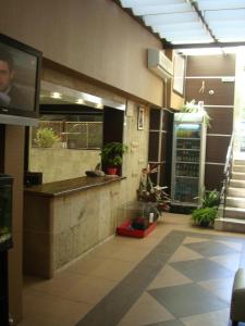 a lobby with a counter and a tv in a building at Guest House Lazur in Burgas City