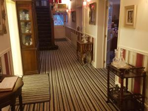 a hallway of a house with a room with a staircase at Andel Lodge in King's Lynn