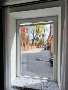 a window with a view of a street outside at design loft morska 7 in Puck