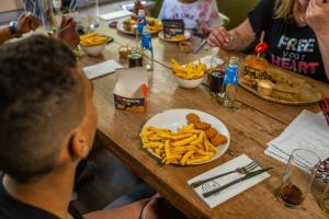 a group of people sitting at a table with fries at EuroParcs Molengroet in Noord-Scharwoude