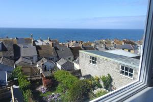 a view from a window of a city and the ocean at Cuddy in Castletown