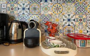 a kitchen counter with a coffee maker and a tea kettle at Lake Apartment Ischia Green in Tenna 
