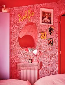 a bedroom with a pink and white patterned wall at Fun Barbie Inspired, 6 Berth Caravan - Camber Sands Holiday Park, near the Beach in Camber +3 photos