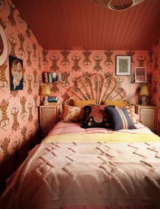 a bedroom with a large bed with pink wallpaper at Fun Barbie Inspired, 6 Berth Caravan - Camber Sands Holiday Park, near the Beach in Camber