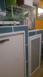 a kitchen with a cabinet with a door in it at Airport Jackson Loft in Catania
