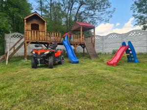 a four wheeler parked in front of a playground at Pensiunea Anisoara in Chişcău