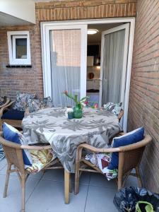 a table with a vase on it on a patio at Pension Schier in Zandvoort