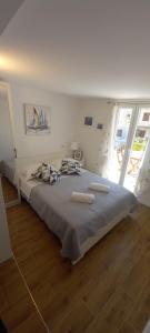 a bedroom with a large bed with two towels on it at Apartmani Robert in Bol +37 photos