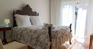 מיטה או מיטות בחדר ב-Villa da Praia