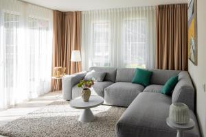 a living room with a couch and a table at COME2rest - Smilga in Juodkrantė