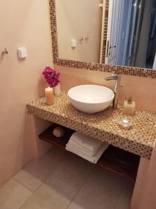 a bathroom with a sink and a mirror at Evilou's House in Krotiri