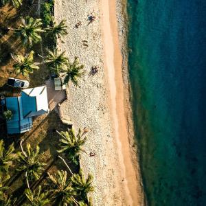 an overhead view of a beach with palm trees and the ocean at Villa Israel Ecopark El Nido in El Nido