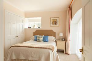 a bedroom with a bed and a window at Balnagown Estates Peat Cottage in Kildary