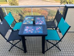 une table bleue et des chaises sur un balcon dans l'établissement Carnac plage T2 avec terrasse Pour 4 personnes, à Carnac