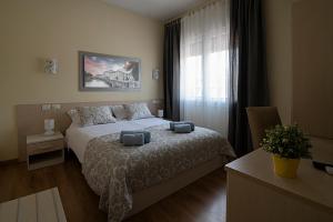 Säng eller sängar i ett rum på Treviso Rooms
