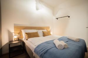 a bedroom with a large bed with towels on it at Bright boutique apartment located 15 min from Stephansdom in Vienna