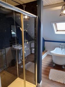 a bathroom with a shower and a tub and a sink at Park Dene Room only in Whitby