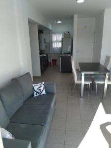 a living room with a couch and a table at Dpto CERCANIA in San Fernando