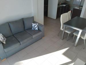a living room with a couch and a table at Dpto CERCANIA in San Fernando