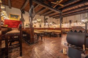 a restaurant with tables and chairs in a large room at Waldkasino Walkmühle in Sangerhausen