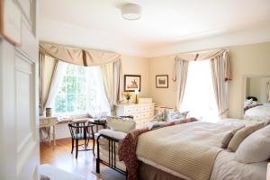 a bedroom with a bed and a table and chairs at Annamult Country House Estate in Kilkenny