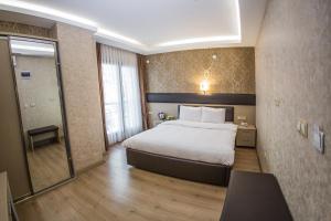 Postel nebo postele na pokoji v ubytování Payidar Hotel