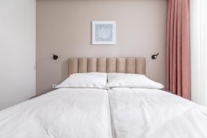 Posteľ alebo postele v izbe v ubytovaní Resort Apartamenty Klifowa Rewal 79