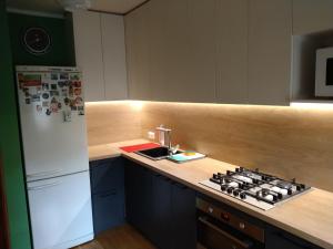 a kitchen with a stove and a white refrigerator at Brivibas Avenue Apartment in Jūrmala