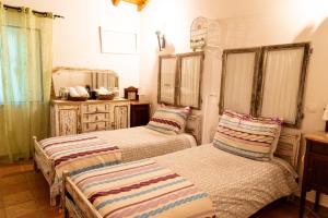 2 Einzelbetten in einem Zimmer mit Spiegel in der Unterkunft Casa do Poço Velho in Grândola