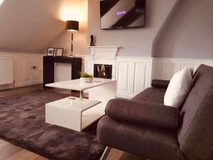 a living room with a couch and a table at Park Dene Room only----Direct Booking for best rates in Whitby