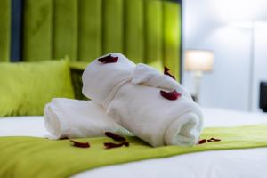 a towel animal laying on top of a bed at Prince de Paris in Casablanca