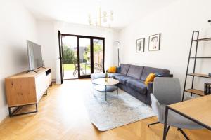a living room with a couch and a table at Lahn-Living I - Gartenapartment - modern und hell in Lahnstein
